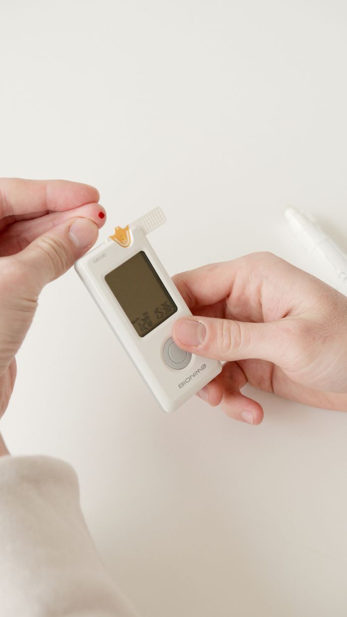 gallery-4 Person checking blood sugar levels with a glucometer, close-up shot.